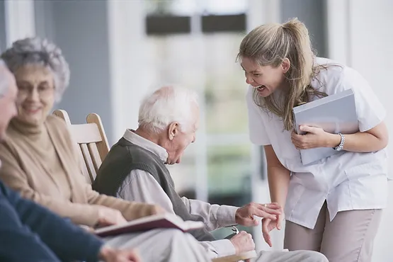 A Nurse And An Elderly Man Laughing