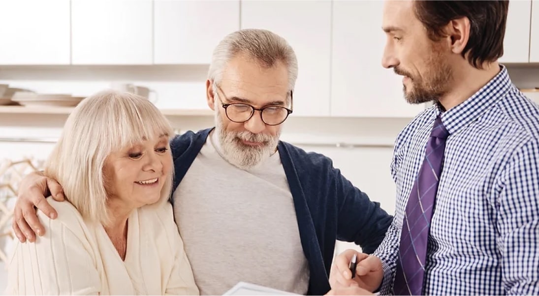 A Happy Elderly Couple Talking With A Lawyer