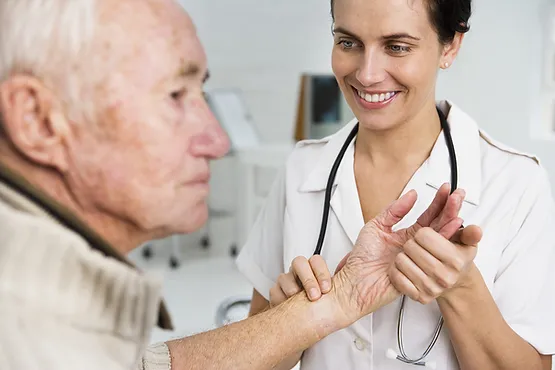 A Nurse Holding An Older Patients Hand